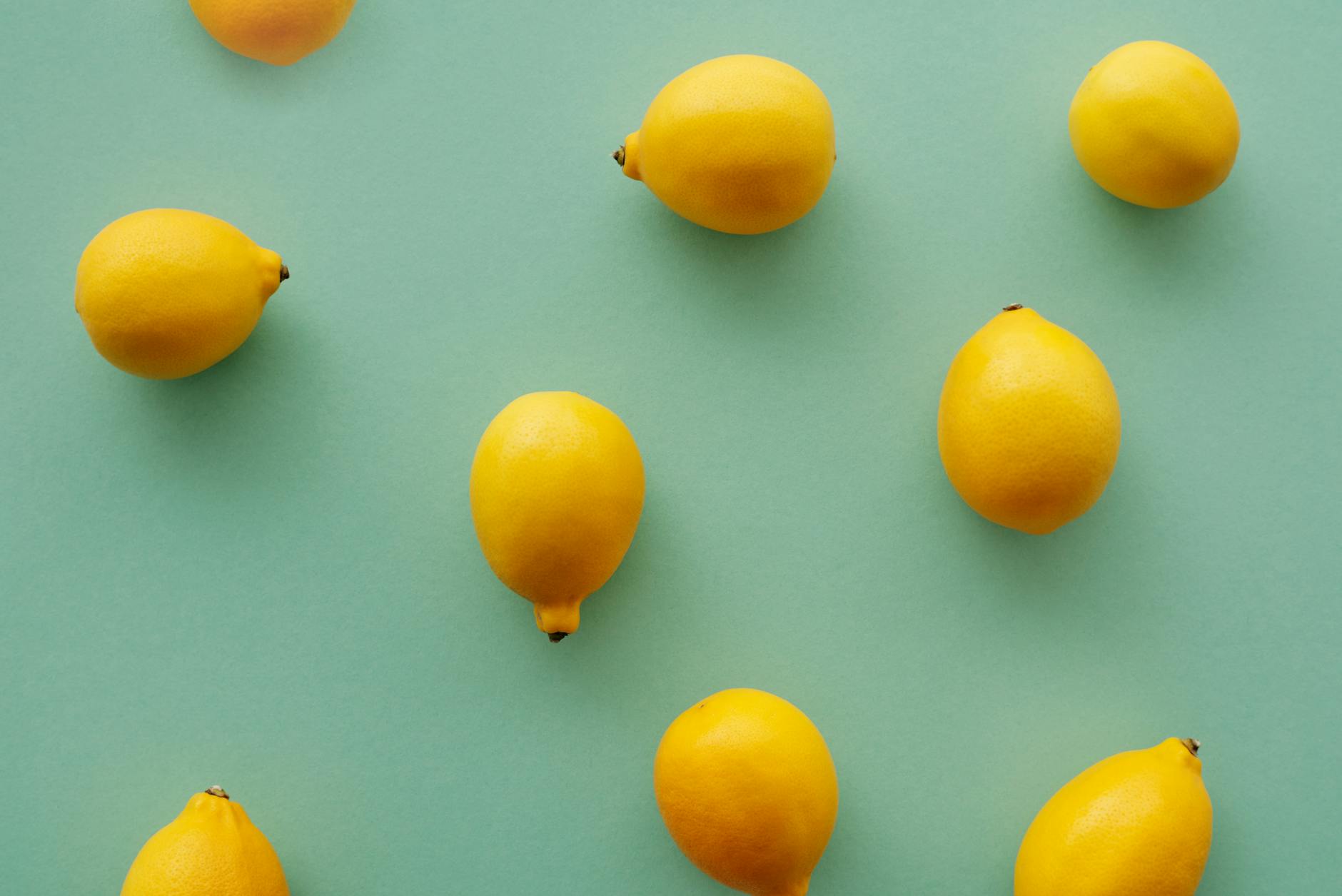 Yellow silicone lemon vibrator surrounded by peeled bananas on a bright yellow background