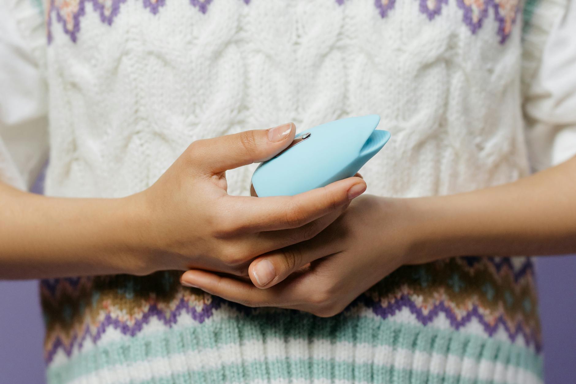 Woman holding blue and pink silicone vibrators, representing different perspectives on intimacy and desire