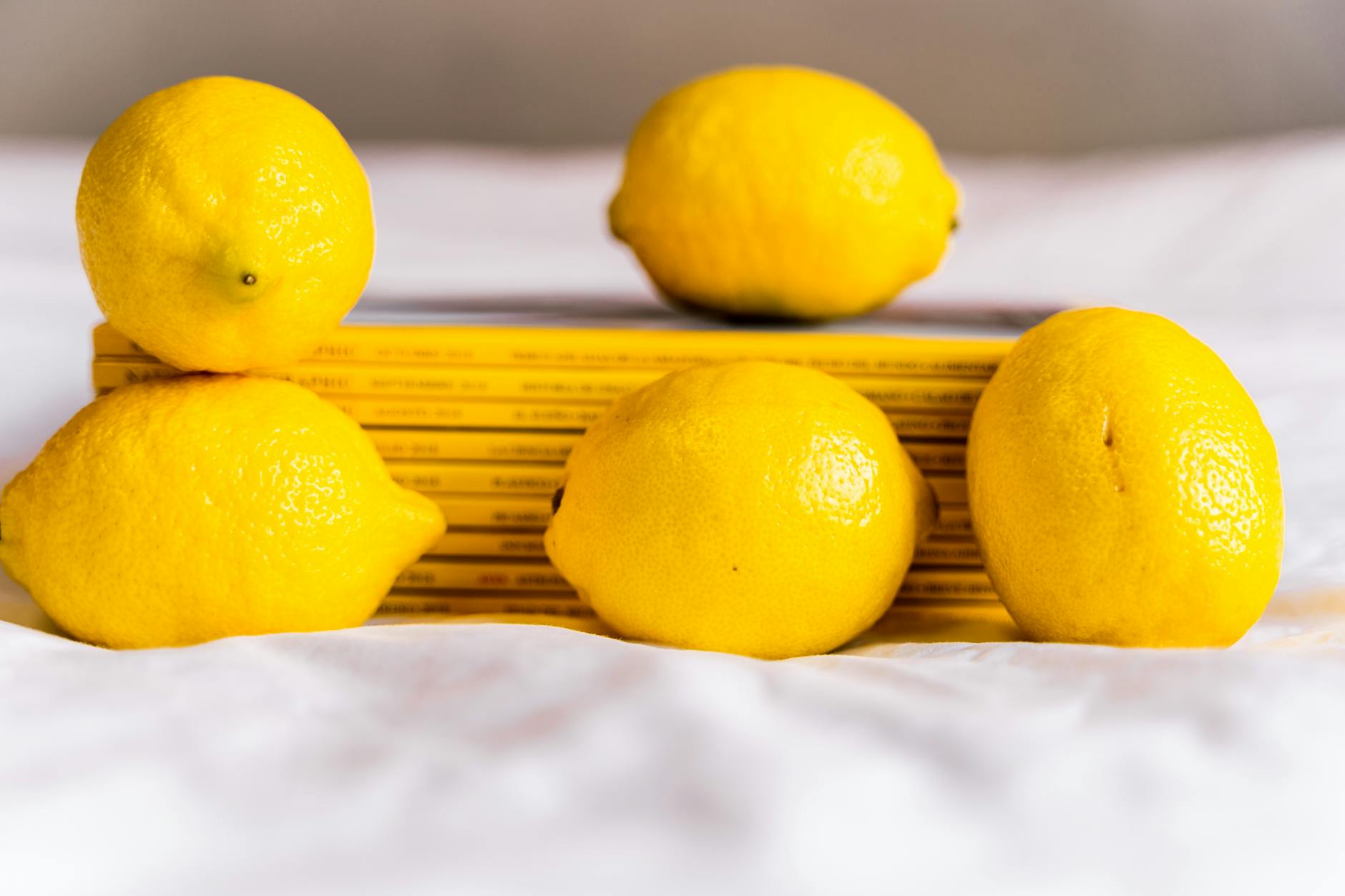 Fresh ripe lemons on yellow background, symbolizing the bright evolution of pleasure with age